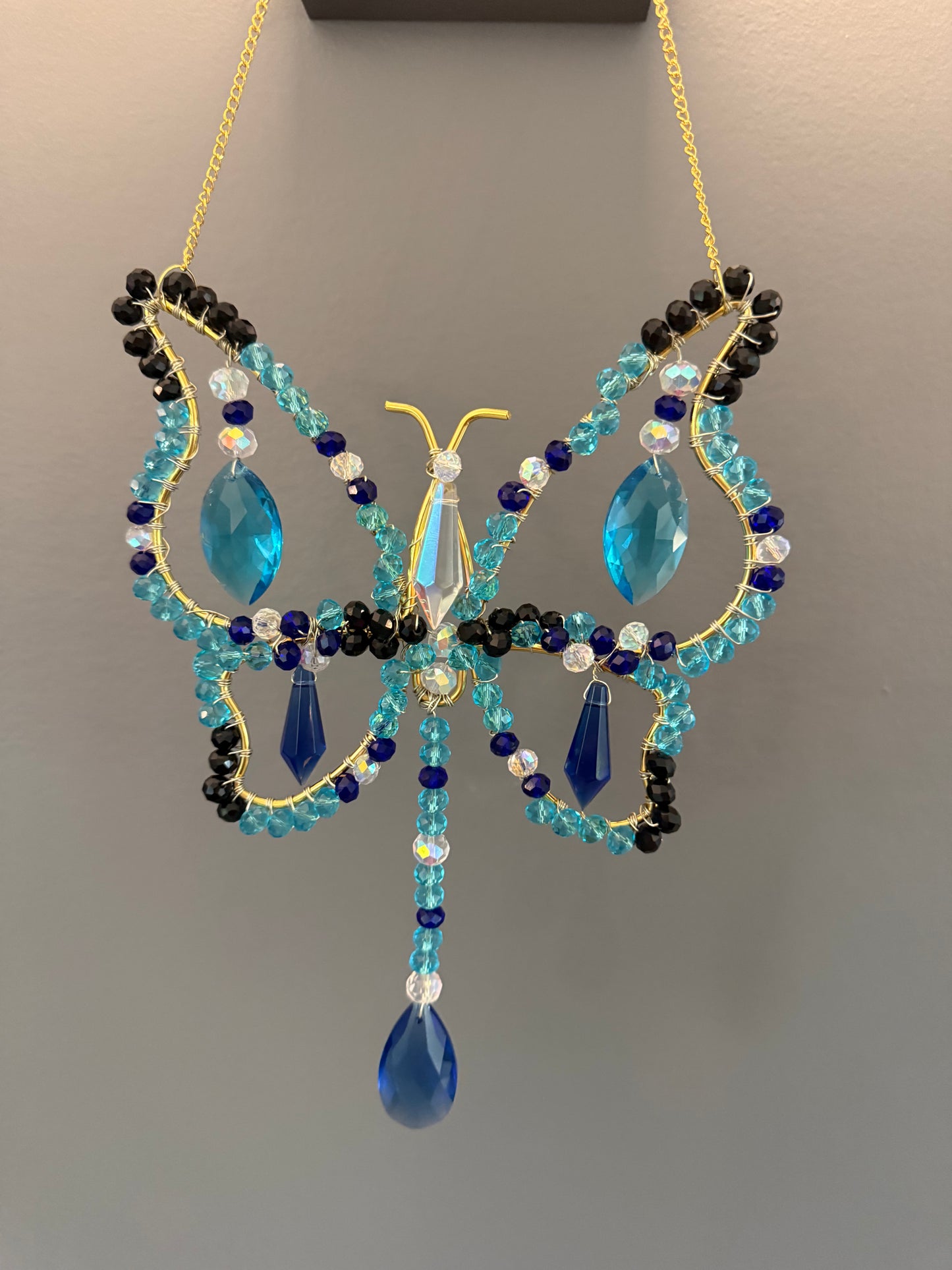 Aqua blue, dark blue, black and white Butterfly Suncatcher